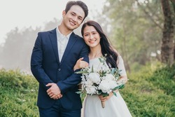 Image of young Asian bride and groom