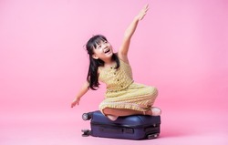 Image of Asian child with suitcase, summer concept