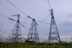 High voltage post or High voltage tower in the field. High voltage towers with sky background. A high voltage power pylons in Ukraine