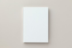 White book blank cover mockup on a beige background, flat lay, mockup