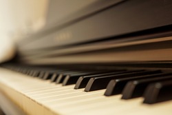 Close-up of piano keyboard with blurred background