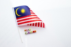 Malaysian flag with alphabet dice assemble to spell malay words 
