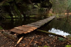 Wooden footbridge across the lake in autumn, mood weather