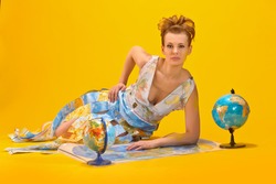 Woman with a world map and globes, concept