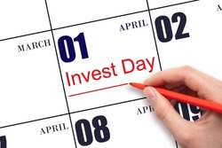 1st day of April. Hand drawing red line and writing the text Invest Day on calendar date April 1. Business and financial concept. Spring month, day of the year concept.