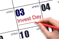 3rd day of April. Hand drawing red line and writing the text Invest Day on calendar date April 3. Business and financial concept. Spring month, day of the year concept.