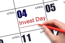 4th day of April. Hand drawing red line and writing the text Invest Day on calendar date April 4. Business and financial concept. Spring month, day of the year concept.