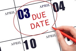 3rd day of April. Hand writing text DUE DATE on calendar date April 3 and circling it. Payment due date. Business concept. Spring month, day of the year concept.