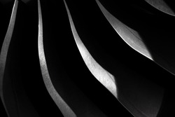 Metallic steel blade on the dark, Aircraft turbojet close up, Black and silver steel abstract texture, modern background with curves and shadow
