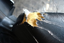 Close up of a damaged motorcycle seat or seat.