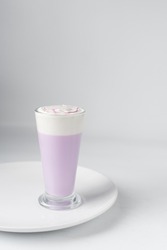 Glass of purple latte with whipped cream, Glass of ube latte