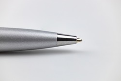 Silver ballpoint pen close-up on a white background.