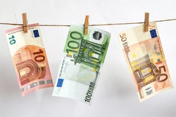euros on a rope, euro with a clothespin on a rope isolated on a white background, Concept - money laundering. euro are dried on the ropes. euros after washing. Money earned honestly. Legalization of