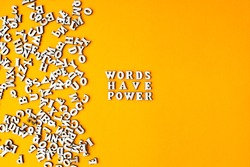 Quote WORDS HAVE POWER made out of wooden letters on bright yellow background. Motivational Words Quotes Concept