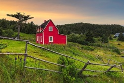 Beautiful red cottage in Tors Cove during sunset , Newfoundland, Canada