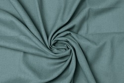 Swirled green-colored mixed fabric texture background. This is made of linen and polyester.