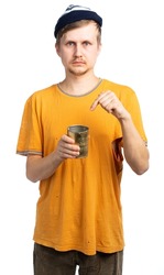 portrait of a man in a torn T-shirt, a hat with a tin can. a homeless vagabond, a poor, needy, beggar boy went broke. isolated, white background