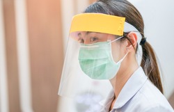 Medical staff wearing face shield and medical mask for protect coronavirus covid-19 virus in CT scan room, protective Epidemic virus outbreak concept