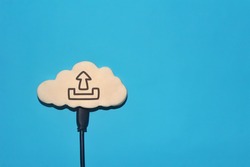Cloud computing, cloud storage, internet concept. White cloud with upload icon on blue background. Copy space for text