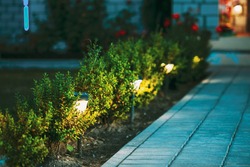 At night solar light outdoor shining beside the pathway stones to the courtyard apartments.