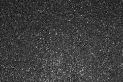 Beautiful Abstract Sparkle Glitter Lights Background. Black, Dark gray. Shine Bokeh Effect. For party, holidays, celebration.
