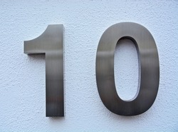 A house number plaque, showing the number ten (number 10)