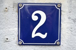 A blue house number plaque, showing the number two (number 2) 