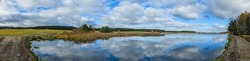 panorama landscape with pond, reeds and clouds