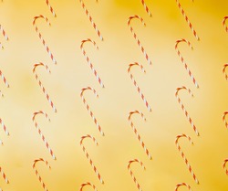 Candy cane for party design on yellow background.Creative minimal Christmas art. Pattern made with Christmas candies on bright yellow background. Flat lay. Copy space. Minimal composition.
