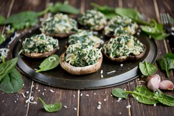 
Stuffed portobello mushrooms. Mushrooms stuffed with spinach, onion, and garlic, with mozzarella cheese. Delicious and healthy snack.