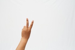 The left hand with the thumb, ring finger and little finger bent to form the number two symbol on a white background