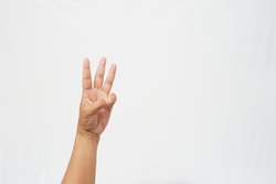 Left hand with thumb and little finger bent to form the number three symbol on a white background