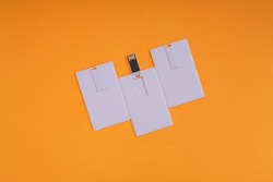 White USB flash disk card on orange background