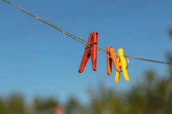 Colorful clothespin clothespins on the hangers. Plastic clothespins in different colors. 