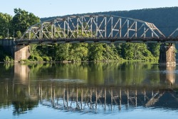 The Tidioute Bridge spanning over the Allegheny River in Tidioute, Pennsylvania, USA on a sunny summer day