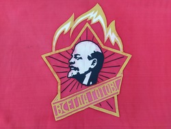Red soviet flag with the image of Lenin and inscription in Russian 