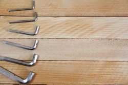 Set of hex keys laid out in ascending order on the wooden background with a copy space