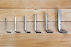Set of hex keys laid out in ascending order on the wooden background