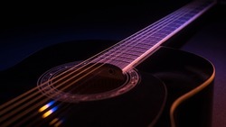 black guitar on a dark background under beam of colored light with copy space. guitar music low-key concept
