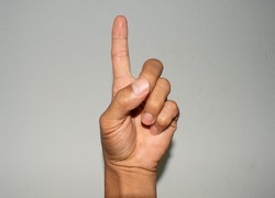one-finger hand symbol signifying victory first white background