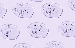 Pattern of cosmetic liquid drops on purple background top view. Skincare product