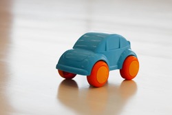 little blue baby car with orange wheels
