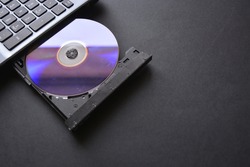 shot of a cd placed on laptop cd player