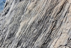 Glacier striations scratched along a rock in the mountains 