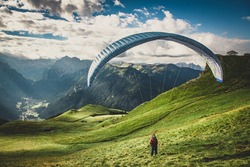 Paraglider in the mountains. Paragliding in the Dolomites. Paragliding in the Alpes