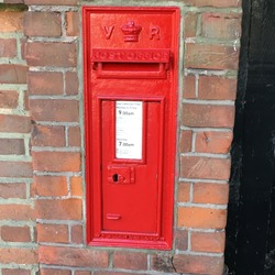 Red Queen Victoria post box, the iconic British public company responsible for providing post office services to the public through its nationwide network of post office branches