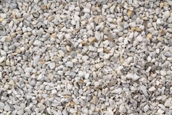 Seamless texture of white stones or gravel. Road gravel, crushed stone. Gravel texture. Crack stones at a construction site. 