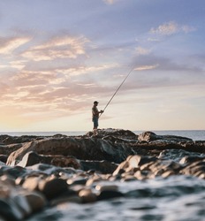Fisher man rock sea rod sunrise