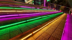 Stairs are decorated with colorful lightings.