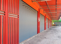 Closed steel shutter door of warehouse, storage or storefront for background and textured.